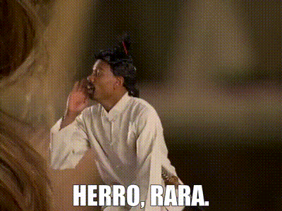 Man in Wig and White Shirt Saying Herro Bara