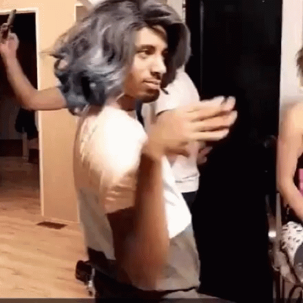 Man In Wig And White Shirt With People