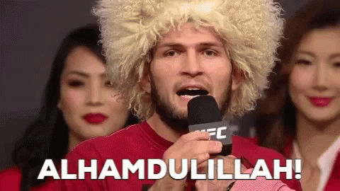 Man In Wig Saying Alhamdulillah Into Microphone GIF