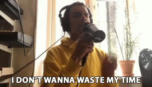 Man In Wig Standing In Front Of Sit Back And Relax Sign GIF