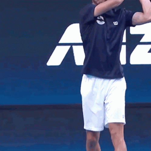Man in Wilson Shirt and White Shorts Playing Tennis