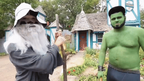 Man in Wizard Costume Next to Green Orc