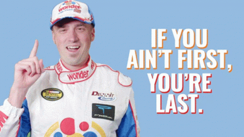 Man in Wonder Hat Points Up Saying If You Ain't First You Last