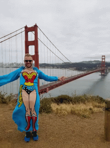 Man In Wonder Woman Costume In Front Of Bridge GIF