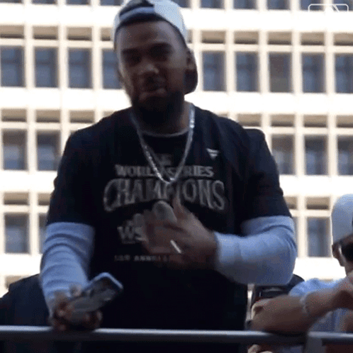 Man in World Series Champions Shirt Holding Phone