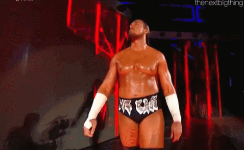 Man In Wrestling Outfit Before Crowd In Dark Room GIF