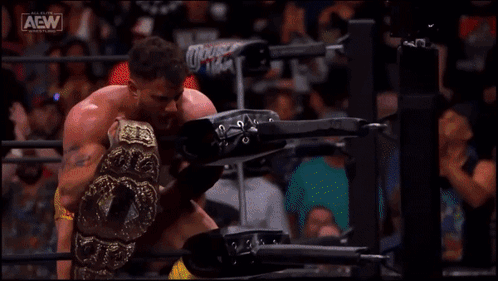Man in Wrestling Ring Holding AEW Belt