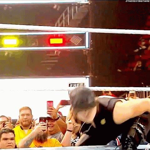 Man in Wrestling Ring Holding Free Sign