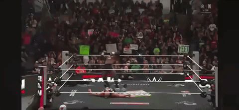 Man in Wrestling Ring Holding I Love You Sign