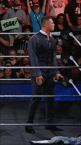 Man in Wrestling Ring Holding Yeah Sign