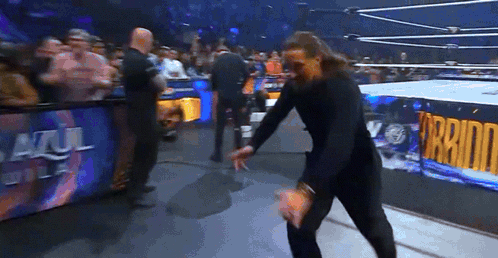 Man in Wrestling Ring With Azul Del Sol Sign