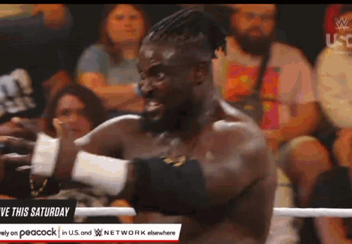 Man in Wrestling Ring With Give This Saturday Sign