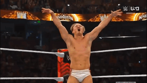 Man in Wrestling Ring With Main Event Sign