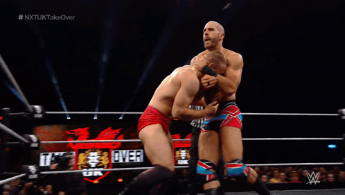 Man in Wrestling Ring With NXTUK Takeover Screen