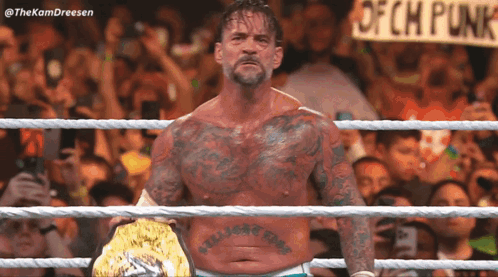 Man in Wrestling Ring With Ofch Punk Sign