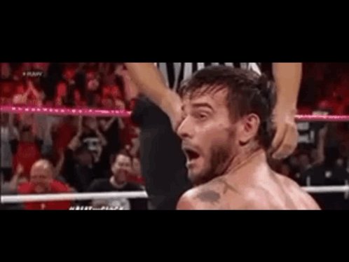 Man in Wrestling Ring With Referee