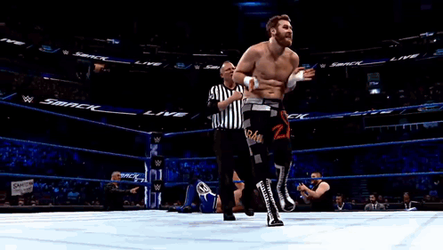 Man in Wrestling Ring With Smack on Walls