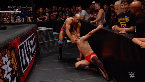 Man in Wrestling Ring with W Logo