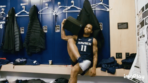 Man In Xavier Jersey Sitting GIF