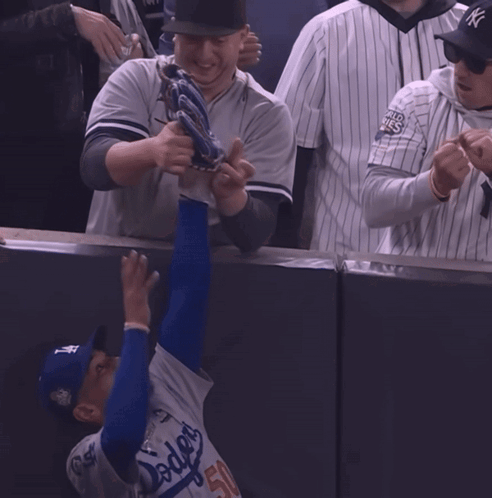 Man in Yankees Jersey Reaching for Ball
