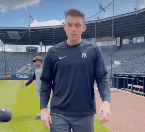 Man In Yankees Shirt In Front Of Stadium GIF