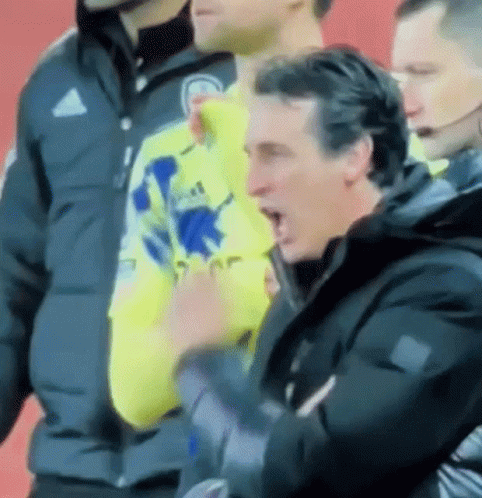Man in Yellow Adidas Shirt Next to Man in Black Jacket
