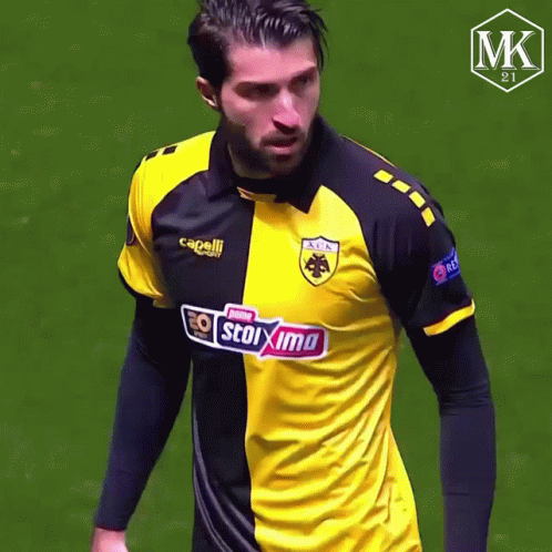 Man in Yellow and Black Stoixima Shirt