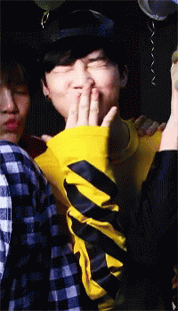 Man In Yellow And Black Striped Shirt Covering Mouth GIF