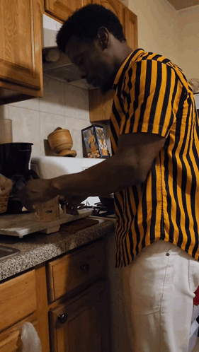 Man in Yellow and Black Striped Shirt Preparing Food