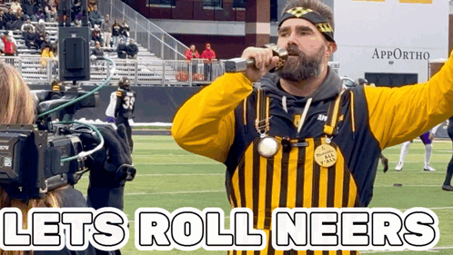 Man in Yellow and Black Striped Shirt Sings Let's Roll Neers