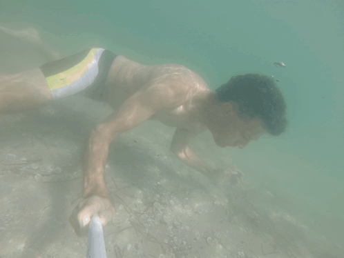 Man in Yellow and Black Swimsuit Swimming