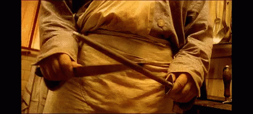 Man in Yellow Apron Holding Sword