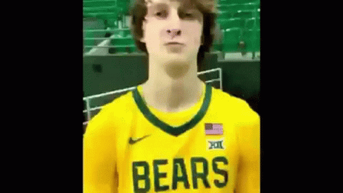 Man in Yellow Bears Jersey in Front of Green Bleachers