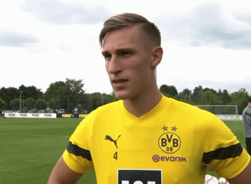 Man in Yellow BVB Jersey on Soccer Field