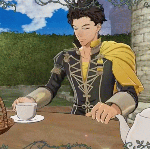 Man in Yellow Cape Sitting at Table with Tea