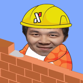 Man in Yellow Hard Hat With Letter X Over Brick Wall