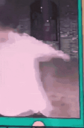 Man In Yellow Hat And Headphones Walking Down Hallway GIF
