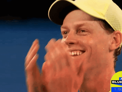 Man In Yellow Hat Applauds Sign Saying Blue GIF