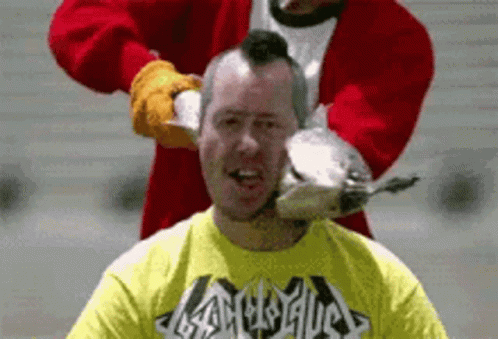 Man in Yellow Heavy Metal Shirt Being Shaved by Santa