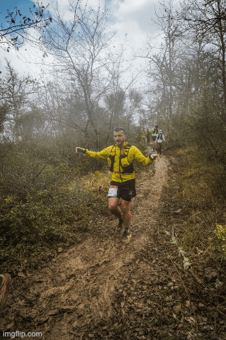 Man in Yellow Jacket and Shorts Running