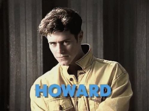 Man In Yellow Jacket By Wall Saying Howard GIF