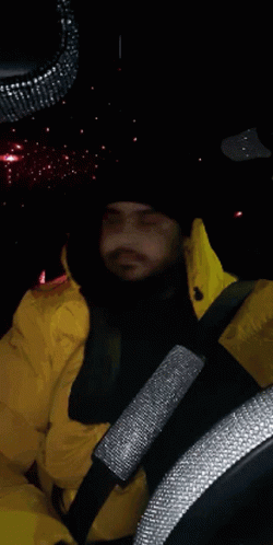 Man in Yellow Jacket Driving Car