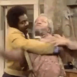 Man In Yellow Jacket Holding Another Man In Yellow Jacket GIF