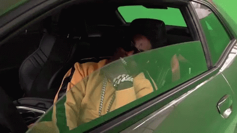 Man in Yellow Jacket in Green Car With Green Screen