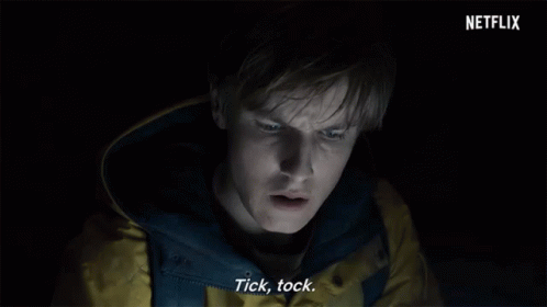 Man in Yellow Jacket Says Tick Tock in Dark Room