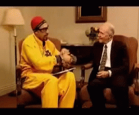 Man in Yellow Jacket Shaking Hands