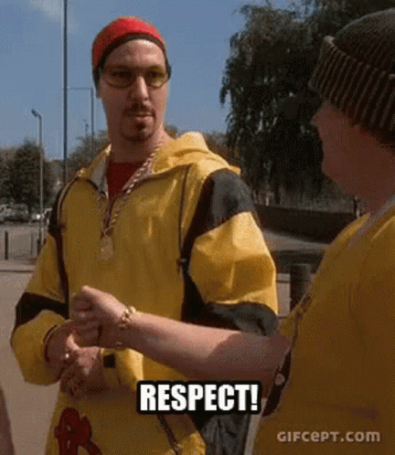 Man in Yellow Jacket Shaking Hands Saying Respect