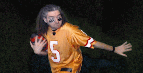 Man in Yellow Jersey Number 5 Throwing Football