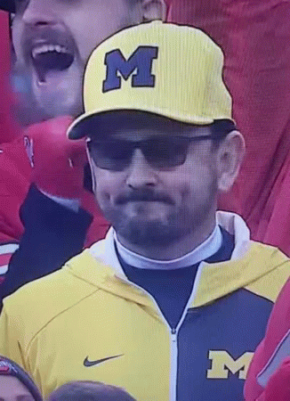 Man in Yellow Michigan Hat and Sunglasses