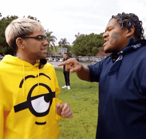 Man in Yellow Minion Hoodie Pointing